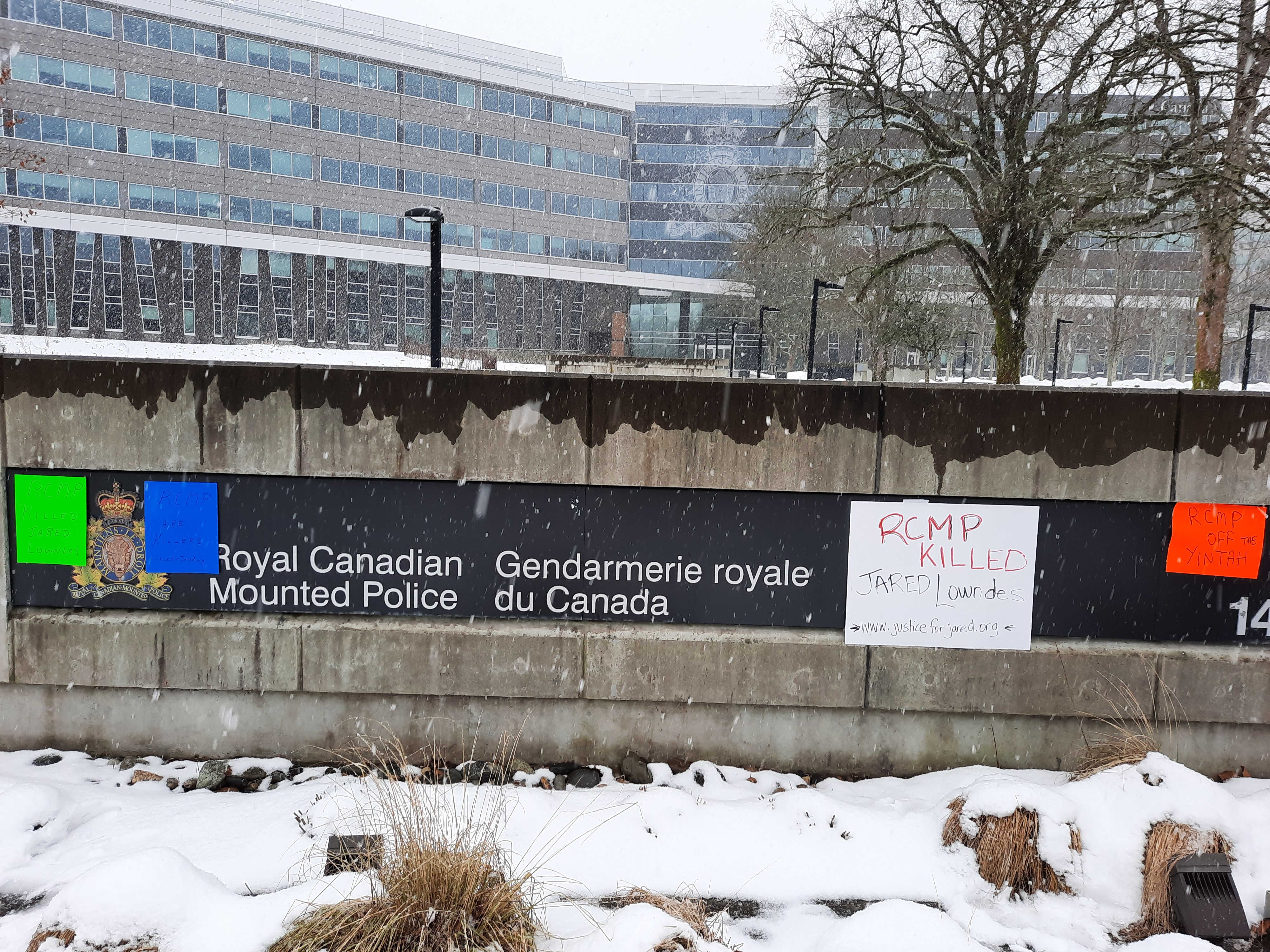 Protest signs in front of BC RCMP HQ in Surrey.
