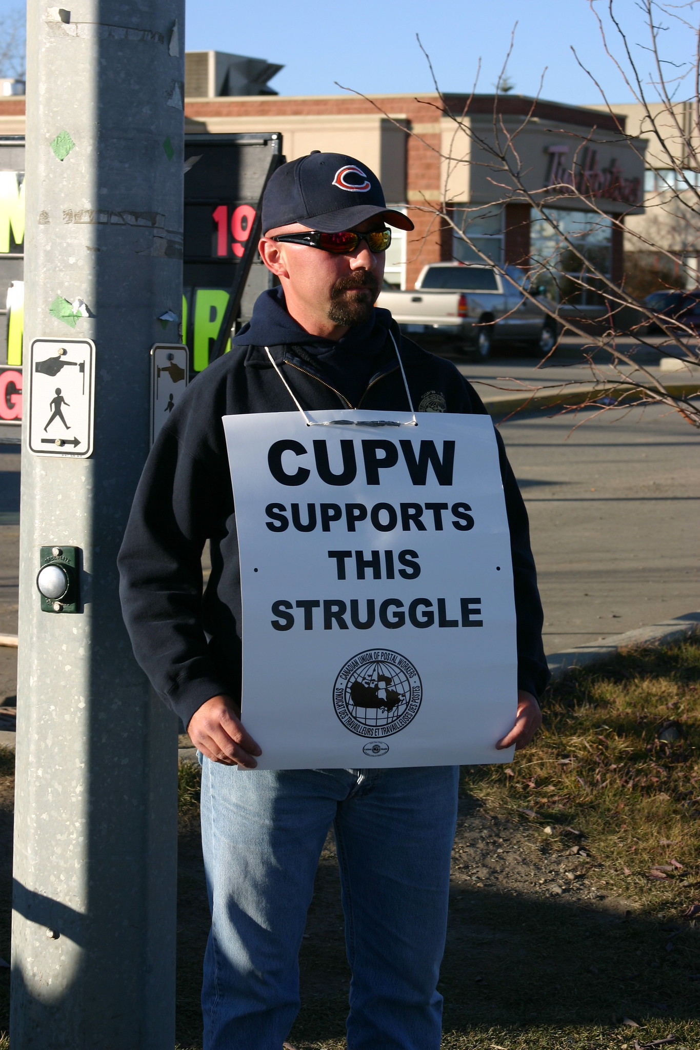 A postal worker showing solidarity with a community struggle. (Image: Wade Kelly via Flickr)