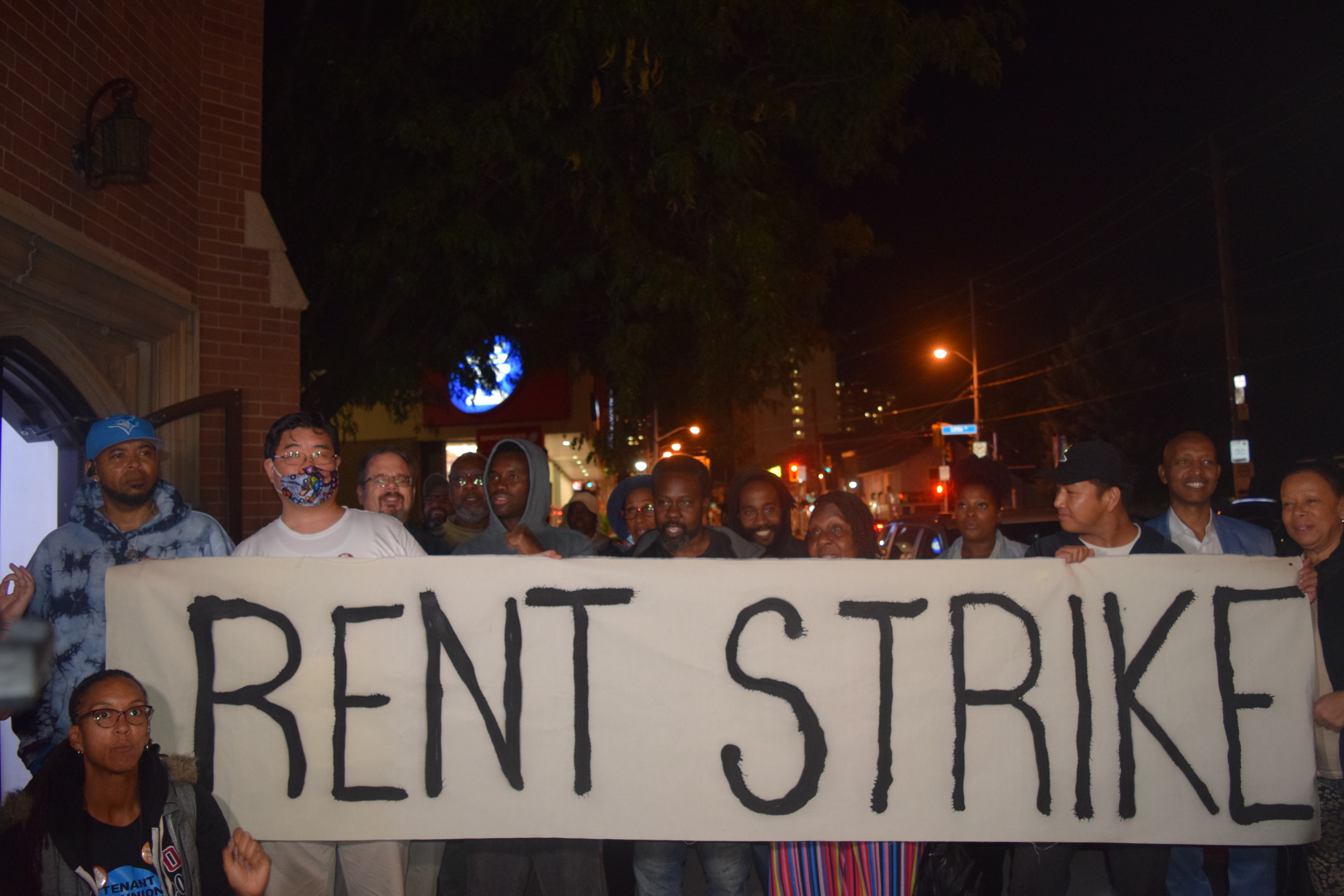 Tenants hold a banner outside the Weston King Neighbourhood Centre, where Toronto Mayor Olivia Chow met with them to discuss their ongoing rent strike. Photo by Fernando Arce. (either this or next pic?)
