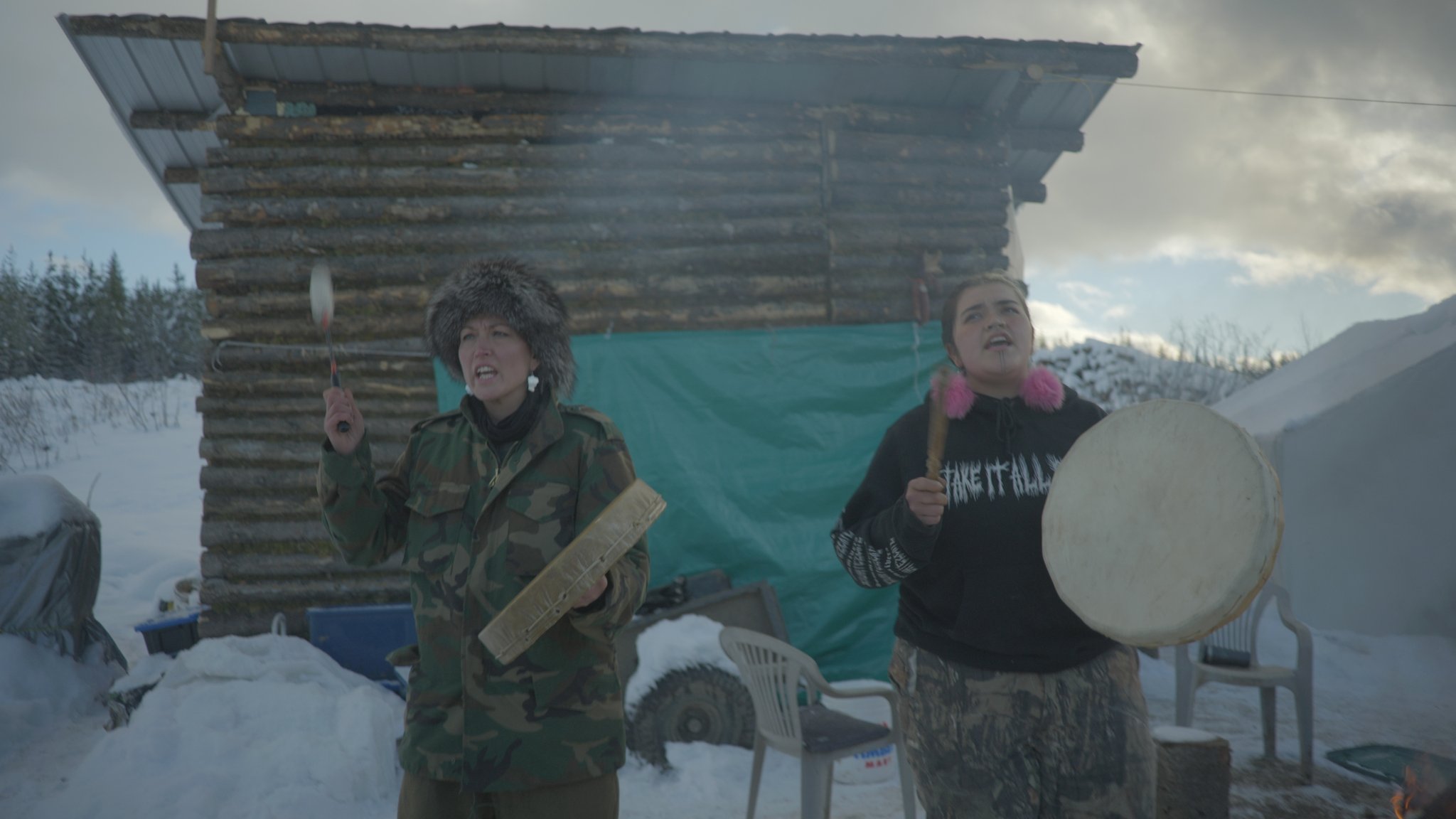 Photo of Wet'suwet'en spokeperson Sleydo' (left) drumming shortly before the RCMP's invasion. Photo credit: Michael Toledano