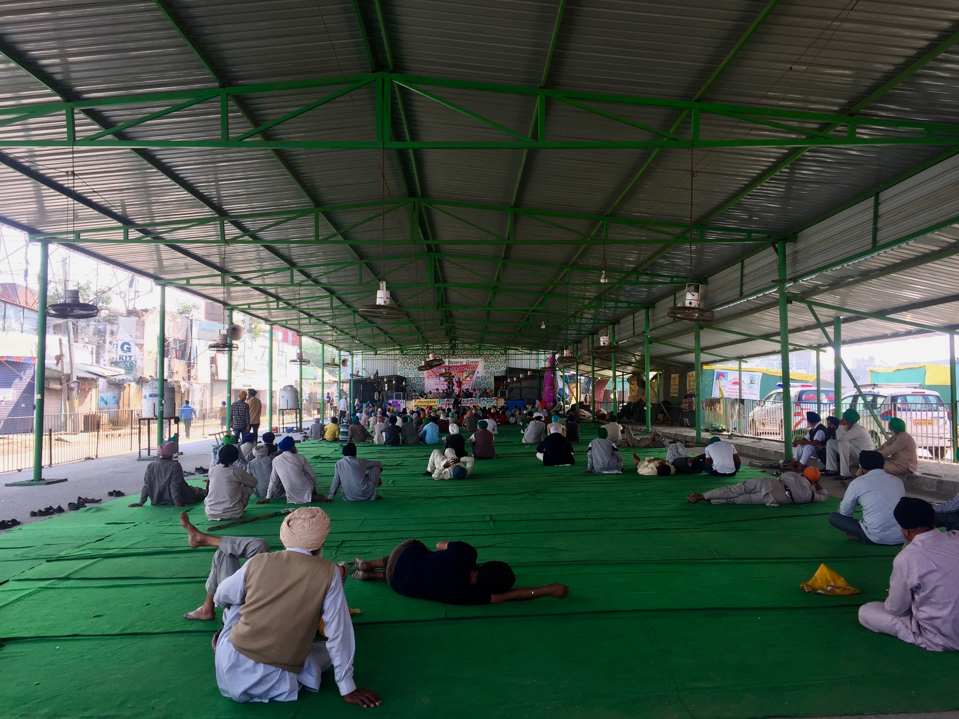 Farmers attend a speech at one of the stages in Singhu. Photo: Vandana K