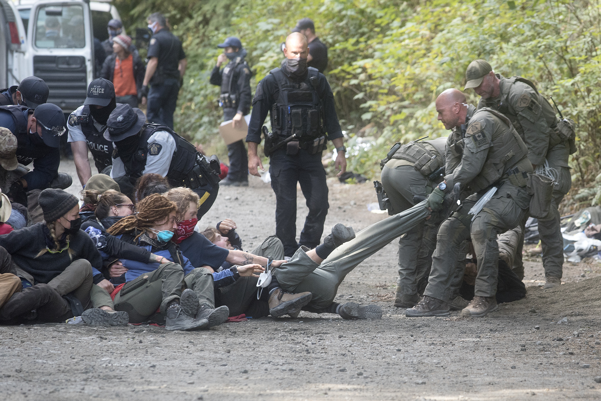 Police and forest defenders at Fairy Creek in the summer of 2021. Police and forest defenders at Fairy Creek in the summer of 2021.