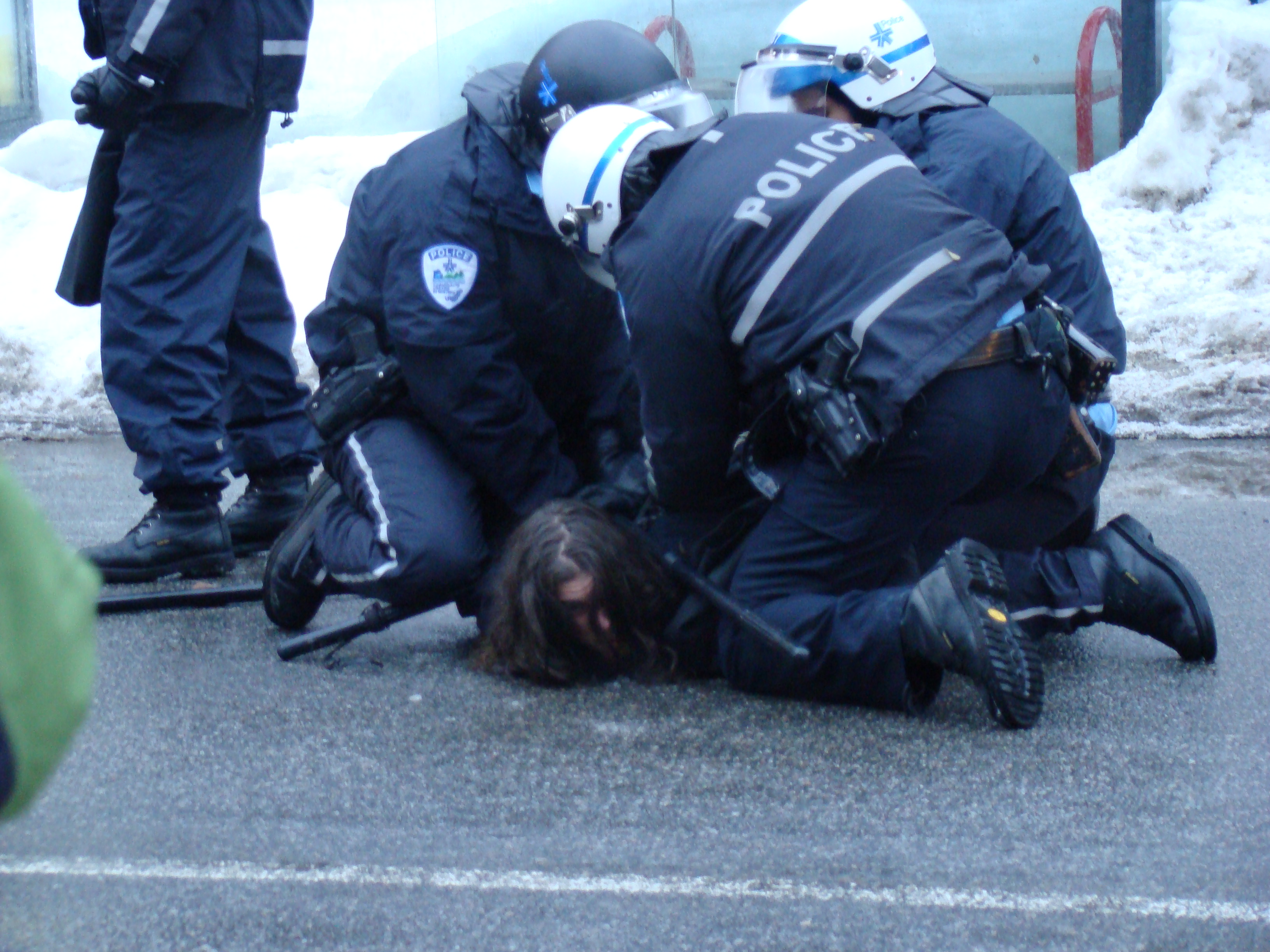 Several police on top of person on the ground