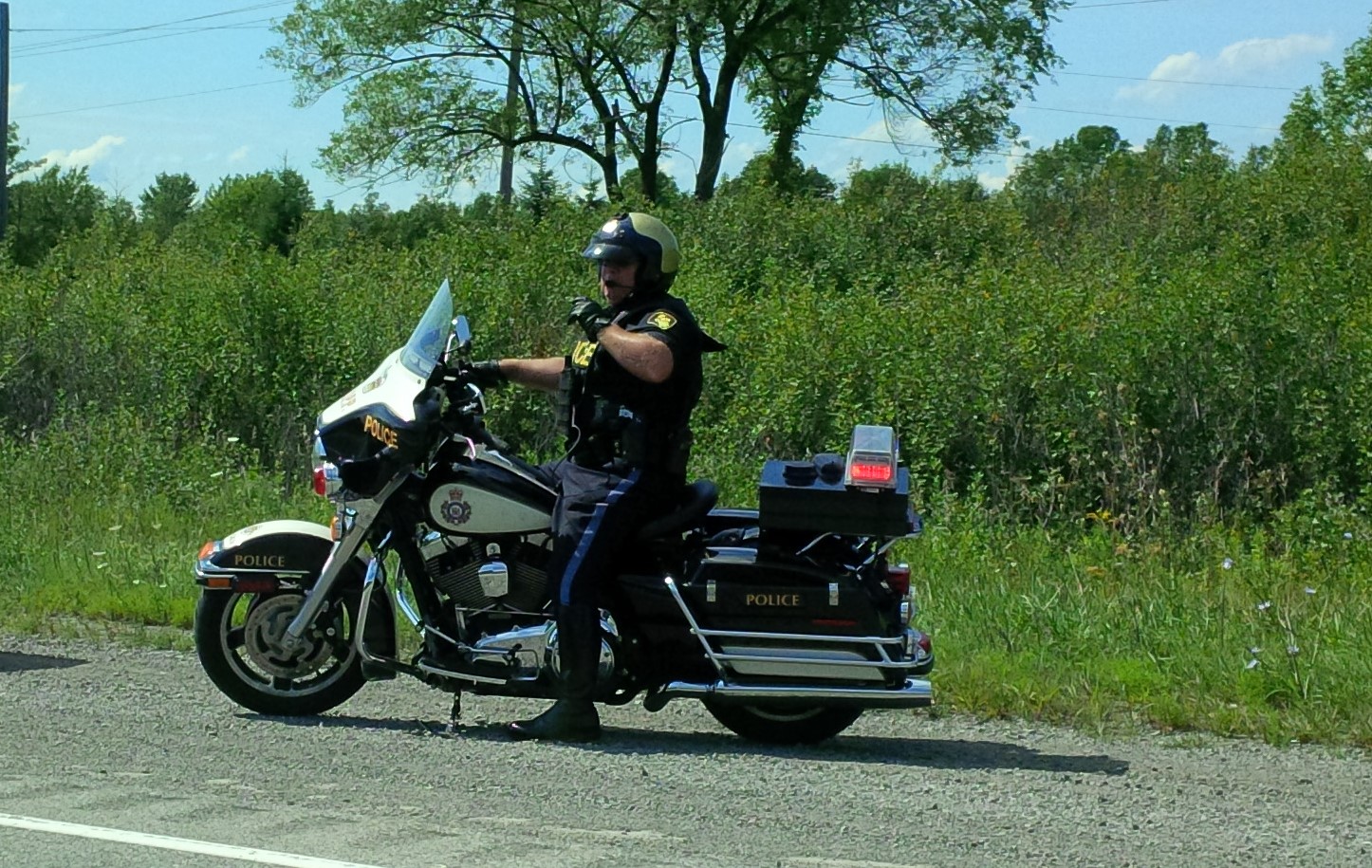 OPP motorcycle cop on road.