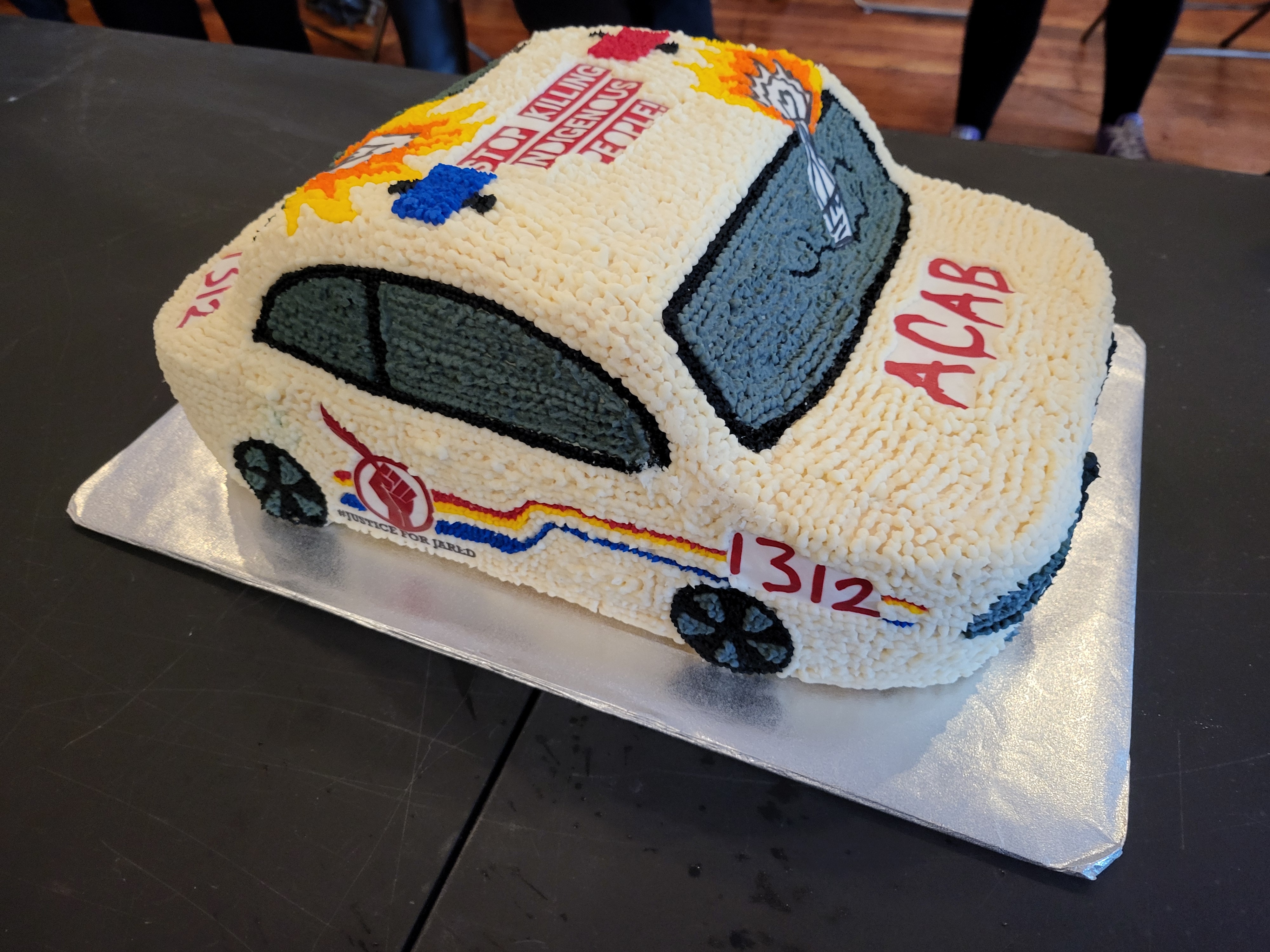 Cake in shape of burning cop car.