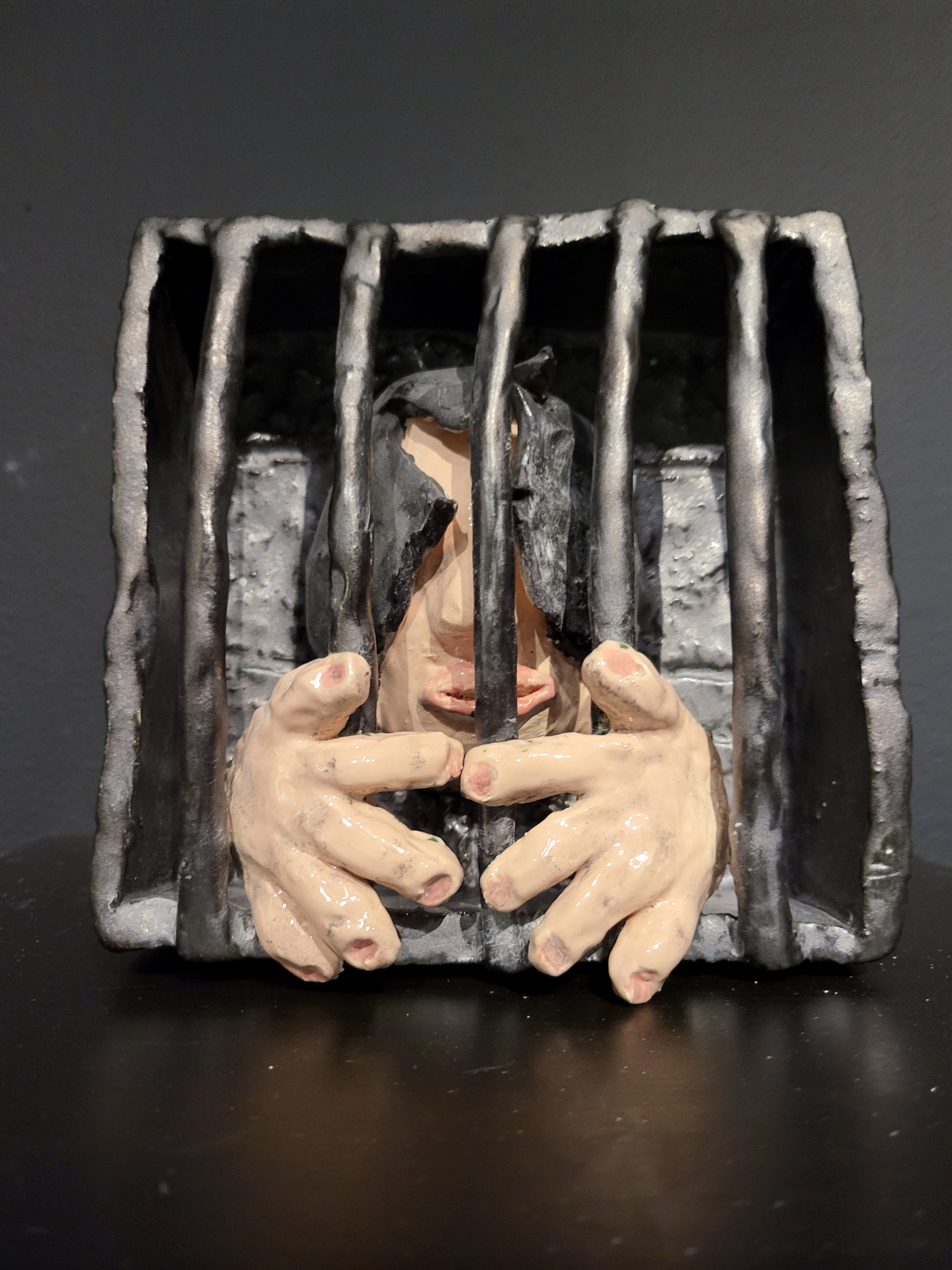 Person in cage sculpture.
