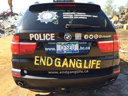Gang Panic Policing Police car with "End Gang Life" painted on it.