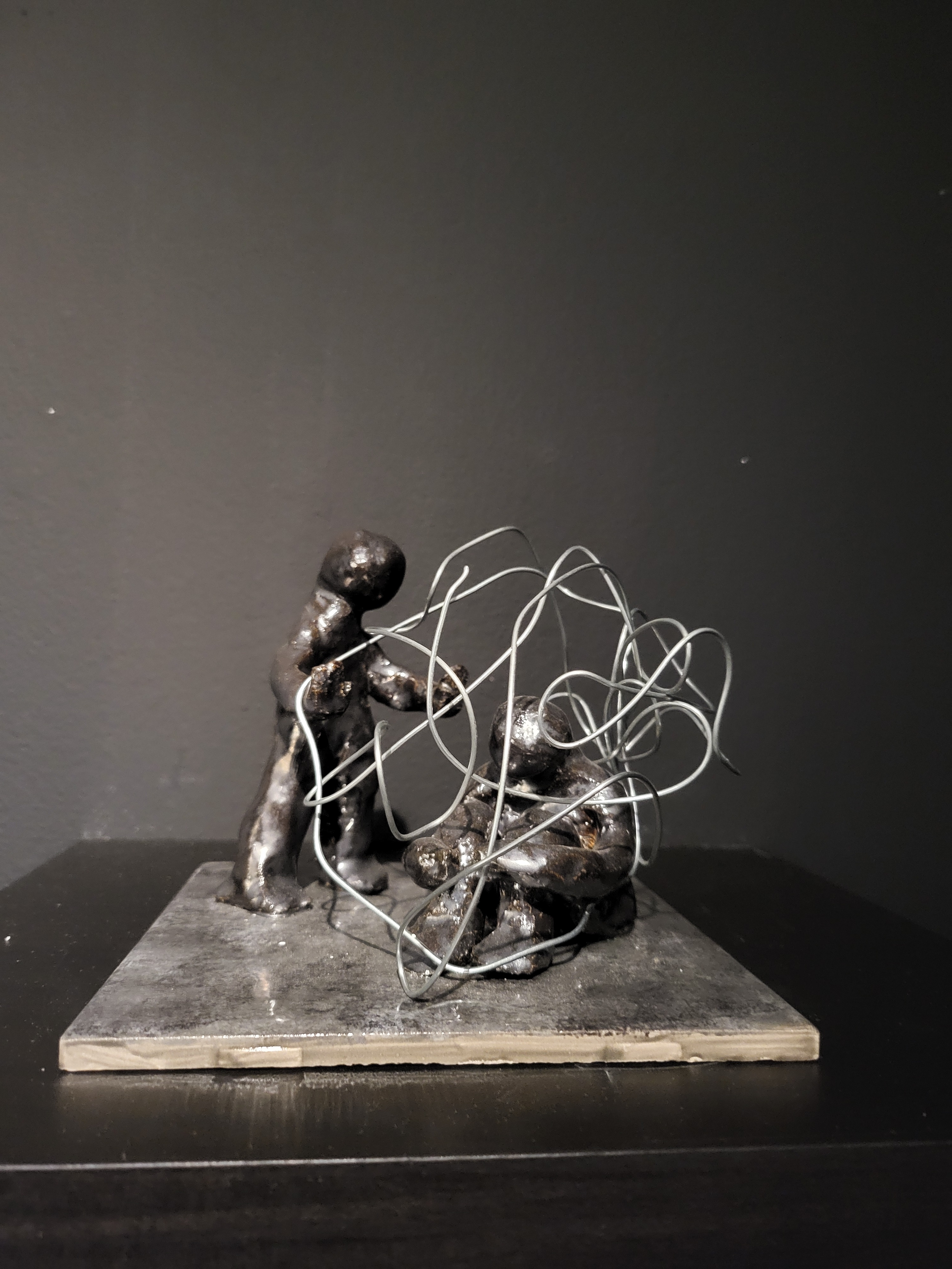 Two people entwined sculpture.