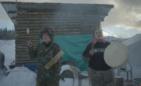 Photo of Wet'suwet'en spokeperson Sleydo' (left) drumming shortly before the RCMP's invasion. Photo credit: Michael Toledano
