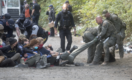Police and forest defenders at Fairy Creek in the summer of 2021.