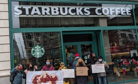 Action outside a New York Starbucks, in solidarity with migrant workers who went on strike over COVID-19 safety at Martin’s Family Fruit Farm in Ontario. Nov 25, 2020. Photo: Justicia for Migrant Workers Group of eight people outside a Starbucks in New York, holding signs in support of workers at Martin’s Family Fruit Farm in Ontario. Nov 25, 2020. Photo: Justicia for Migrant Workers
