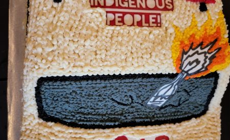 ACAB Cake. In shape of cop car. Says, "Stop killing Indigenous people" on top.