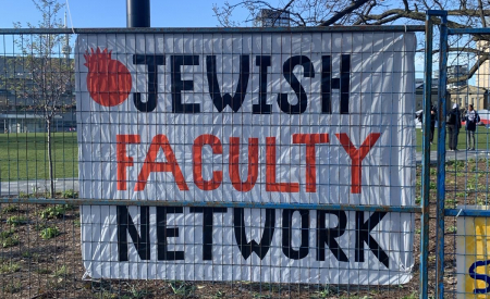 Photo of a banner reading "Jewish Faculty Network" on fencing outside the pro-Palestine encampment at the University of Toronto.